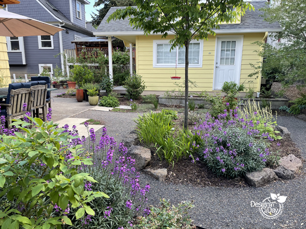 Designed landscaping that includes existing patio and creates privacy in Kerns neighborhood.