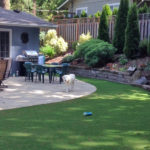 Stone patio with synthetic lawn