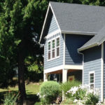 Soft plantings soften studio porch entry.