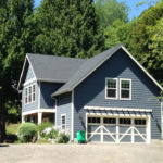 The studio facing the house has a sitting porch and soft plantings.