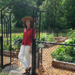 Carol standing at the entrance to community garden at Rocky Pointe Marina 7 23 2014