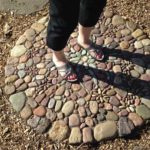 My sister's feet on a Jeffrey Bale stone mosiac landing.